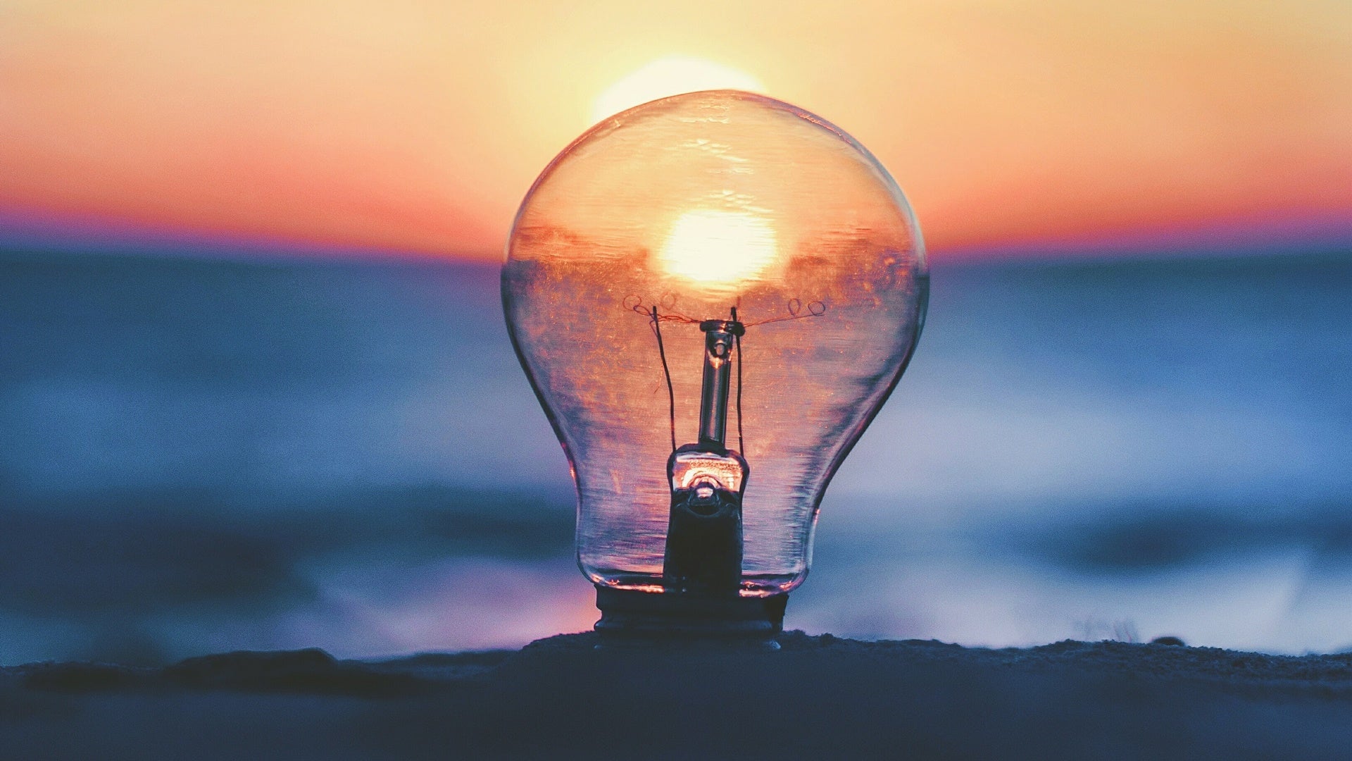 sun rising with light bulb for innovation concept