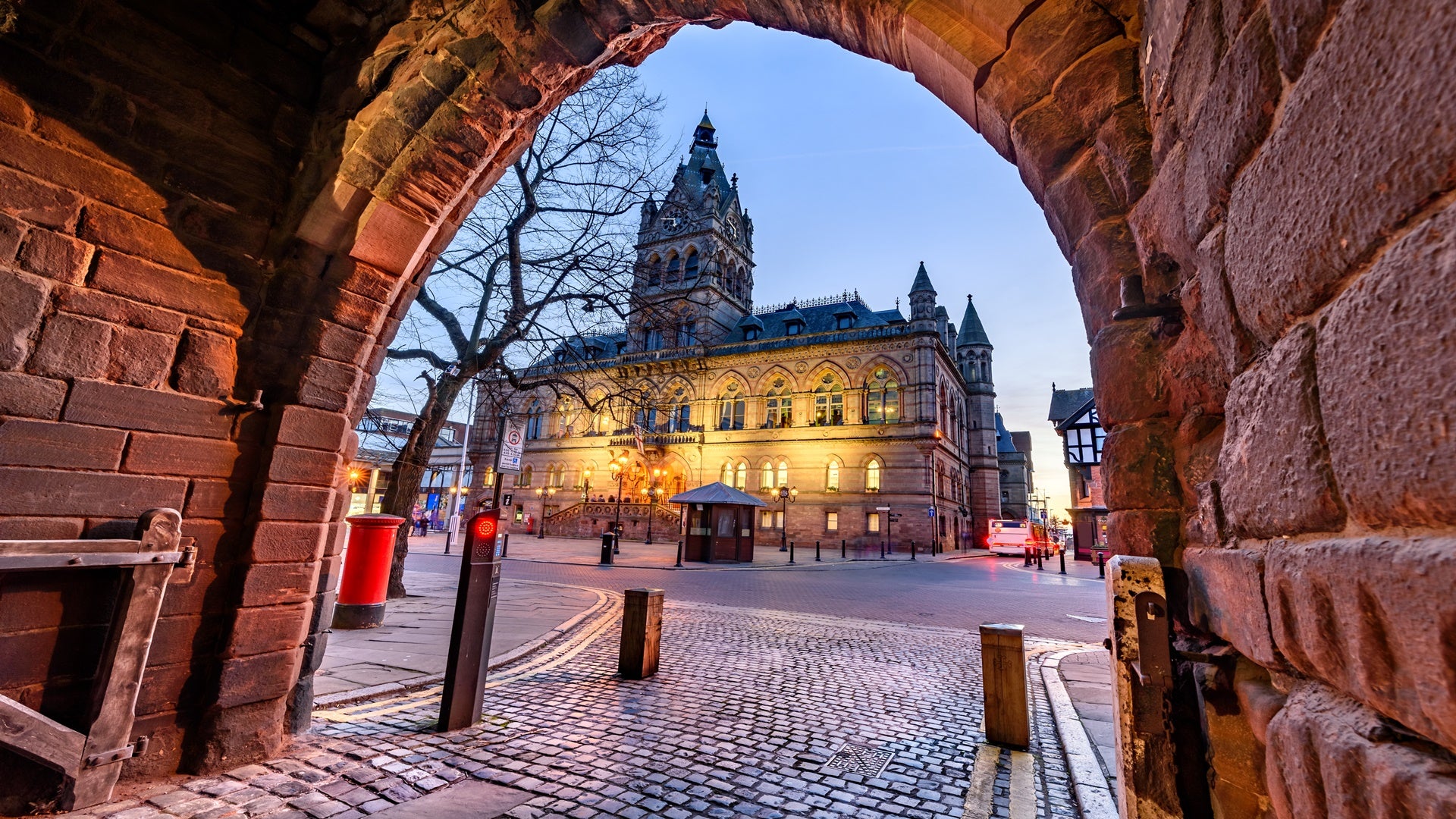 The grey and red sandstone, Gothic style Town Hall with its tower and spire of Chester city, UK.