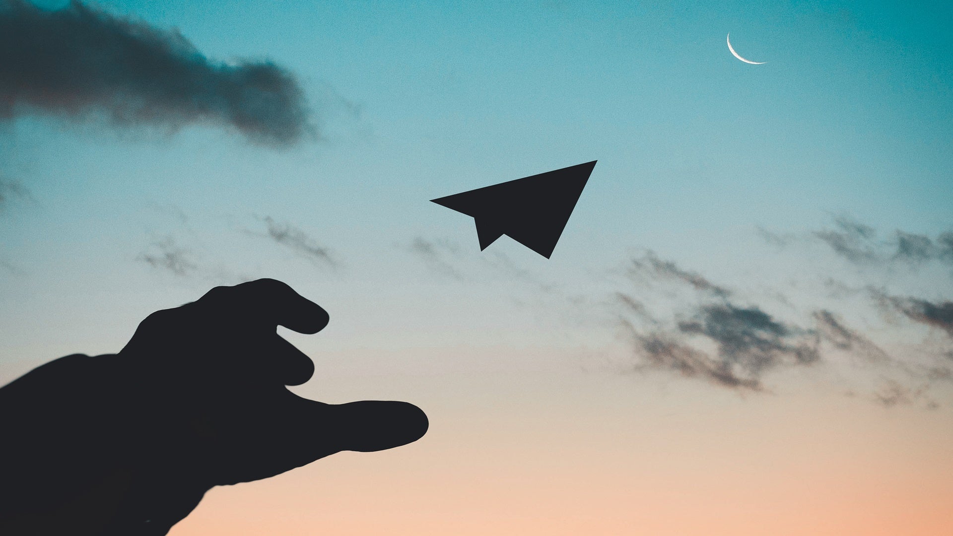 man throwing paper plane into sky / innovation concept