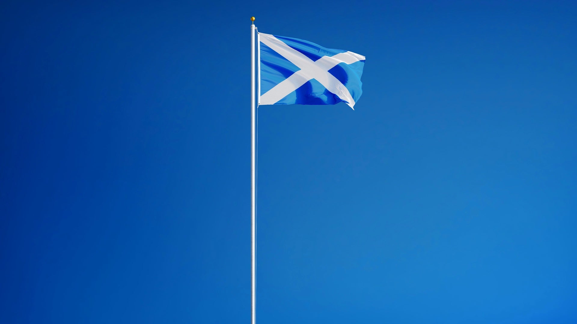 Scotland flag waving against clean blue sky, long shot, isolated with clipping path mask alpha channel transparency